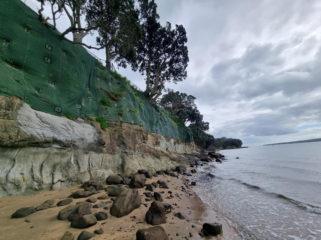 Anchored mesh protecting a coastal cliff above the beach at Vauxhall