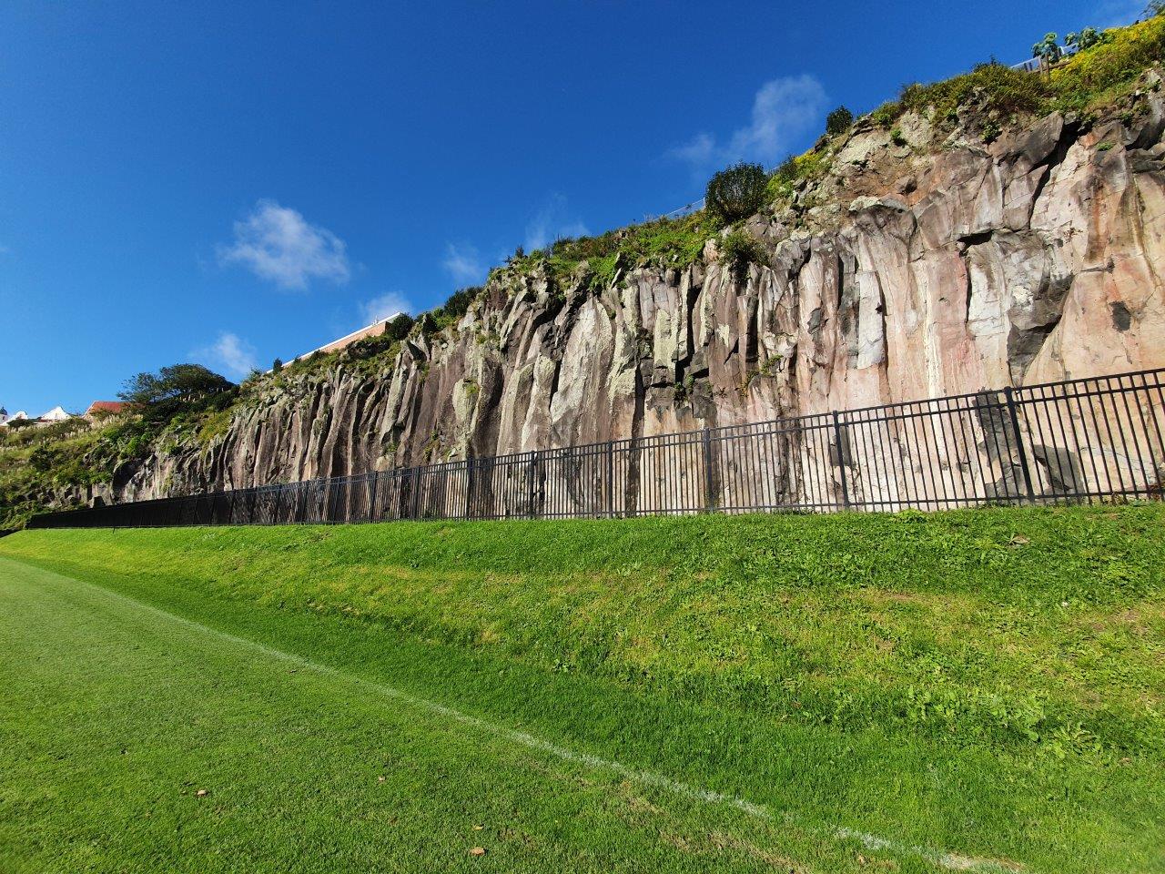 Stabilised rock face above a sports field