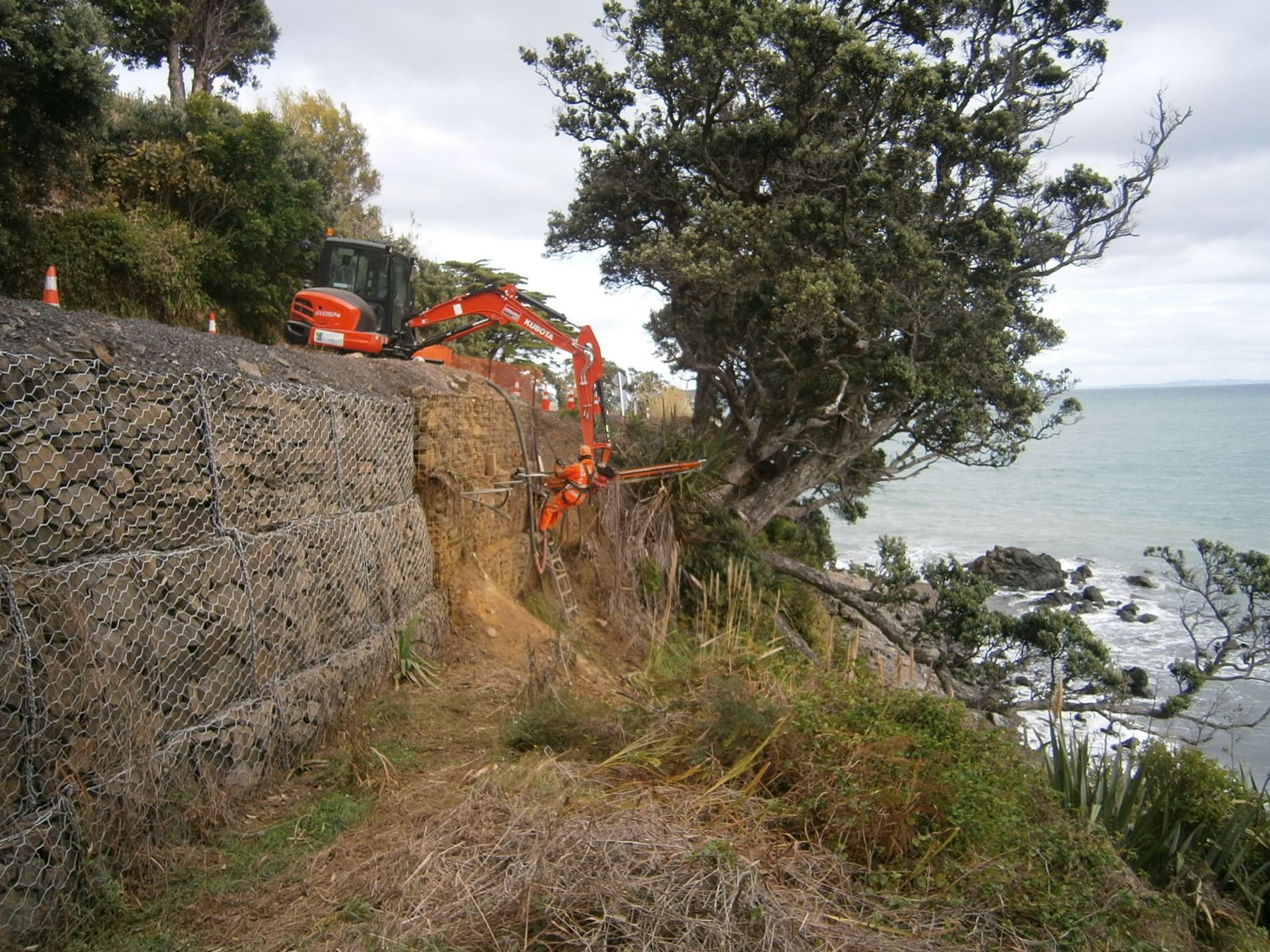 Drilling through failed gabions with temporary casing on a coastal cliff site