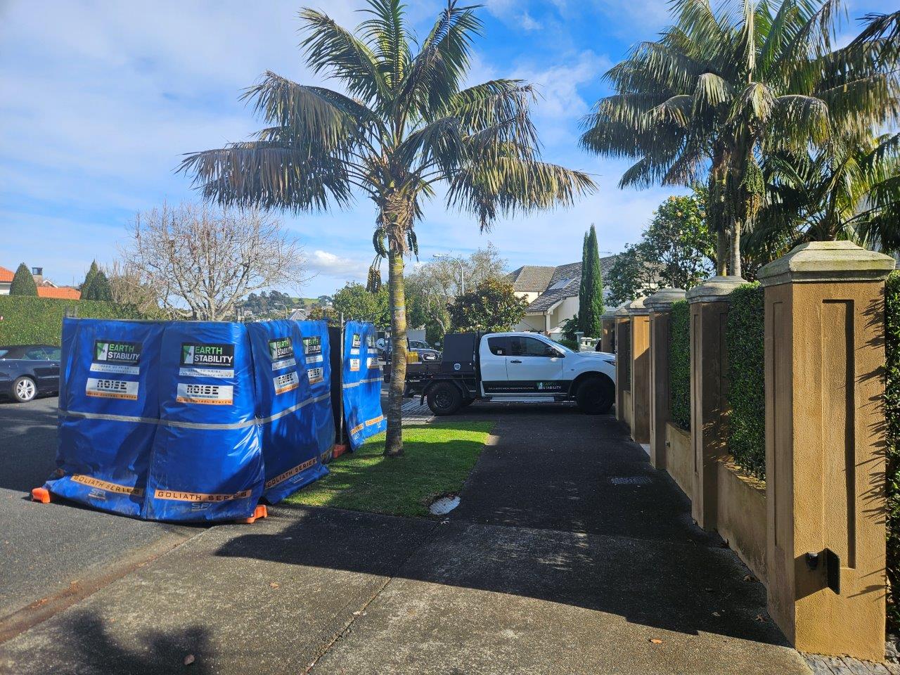 Branded screening barriers and company vehicle at a private home driveway
