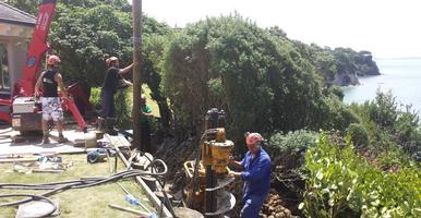 Drilling And Installation Of Timber Poles For Retaining Wall
